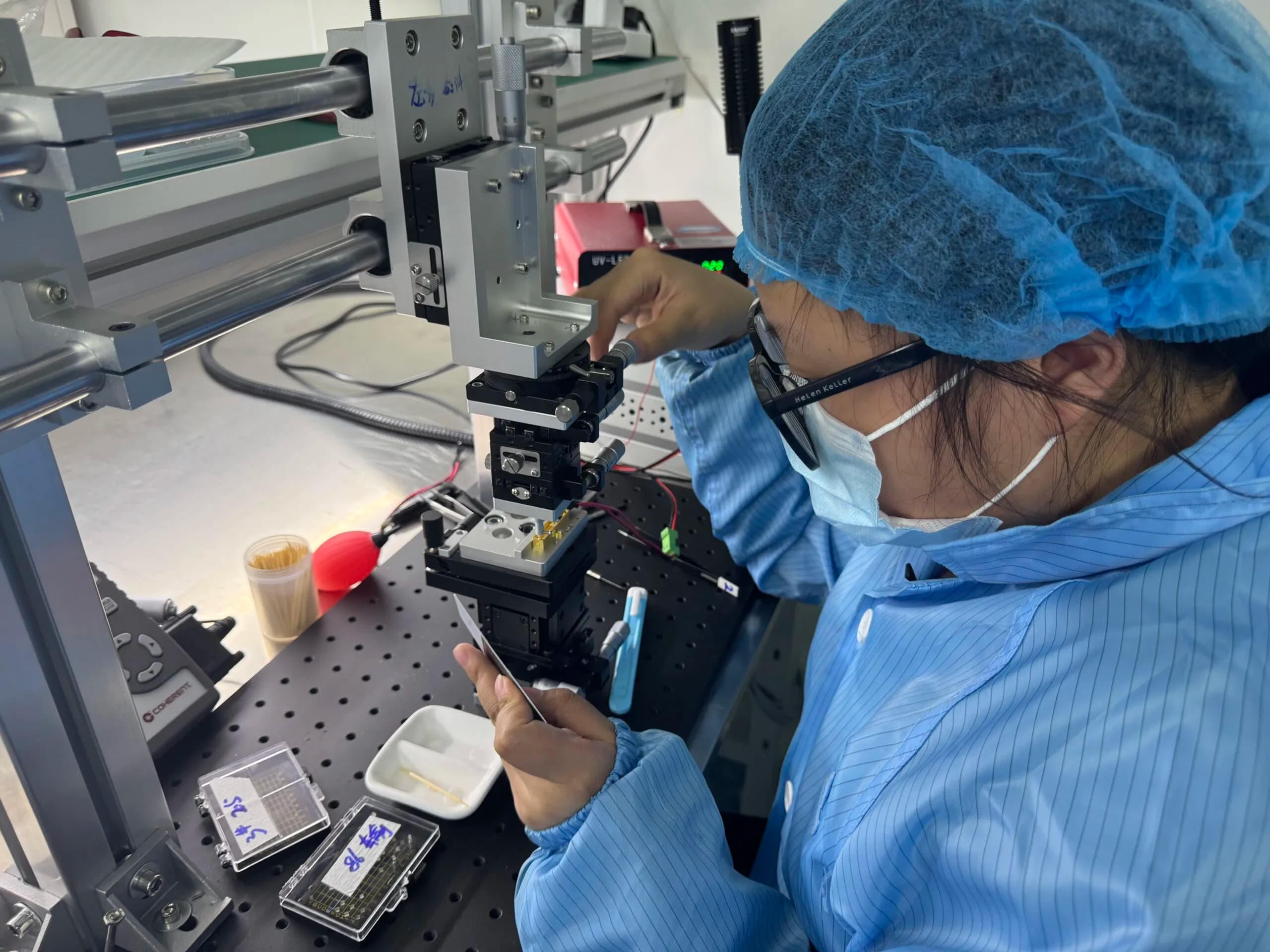 ERDI technician aligning a laser assembly on an optical bench